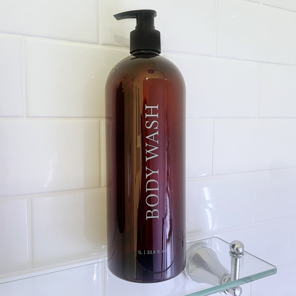 Brown Body Wash refillable 1 litre pump bottle. Bold, minimalist design. UV printed bold serif font. 