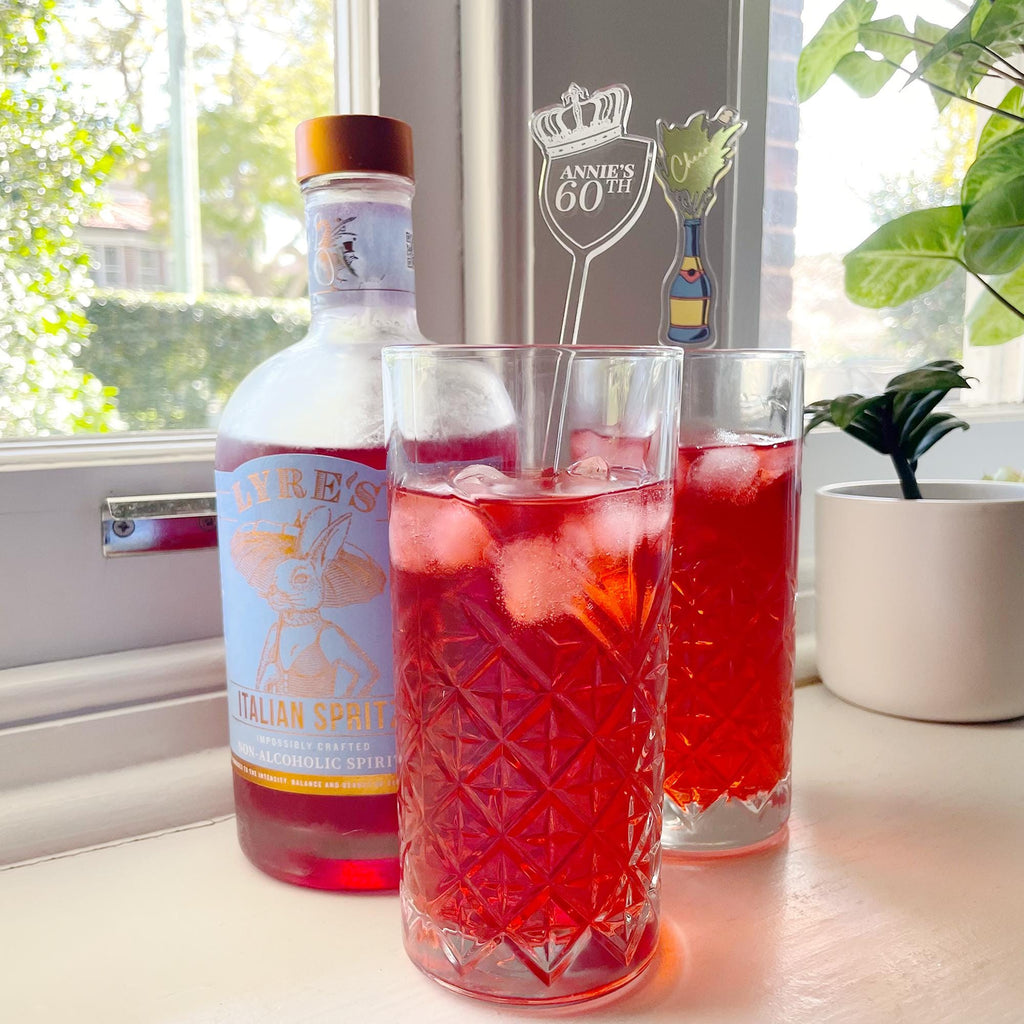 Custom cocktail stirrers in tall glasses. Perfect for birthdays, weddings, hens parties and other events. Add some fun to your cocktails.
