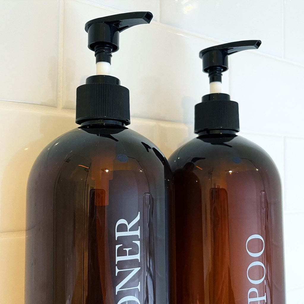 Custom 1 litre shampoo and conditioner refill bottles. Bold serif design. Brown bottles with black pumps.