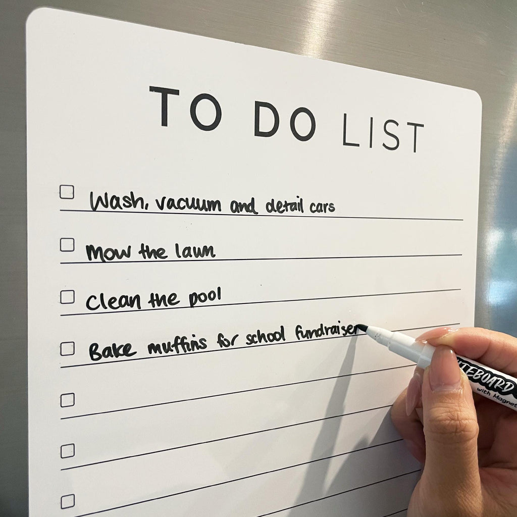 Black whiteboard marker being used with our magnetic To Do list on a fridge.