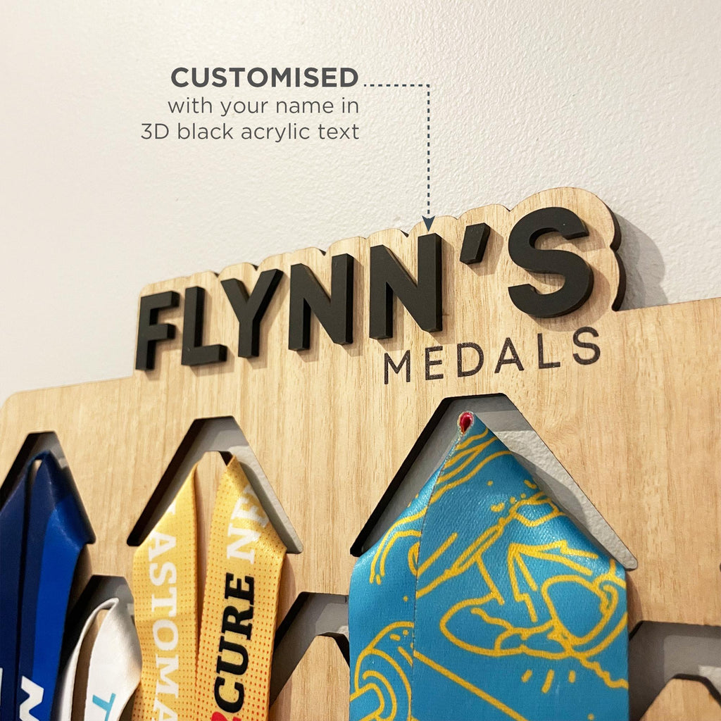 Custom sporting medal display. Personalised name sports medal display hanger with name laser cut out of 3D black acrylic. Perfect Christmas gift for budding athletes and children in sport.