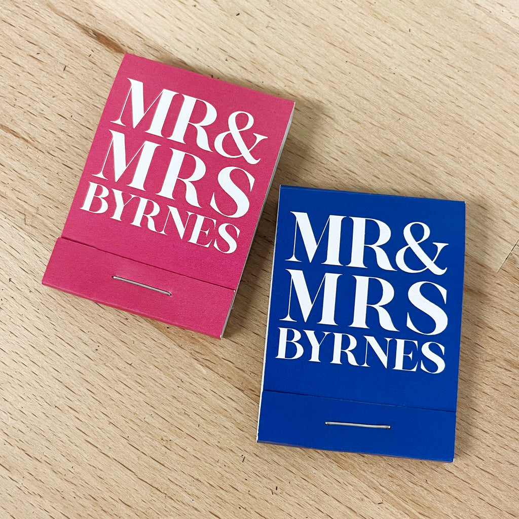 Two wedding matchbooks, one pink and one blue, with 'MR & MRS BYRNES' custom text.