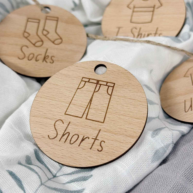 Wooden clothing tags with holes for hanging on baskets. Customised clothing labels for organising your wardrobe, closet and drawers.