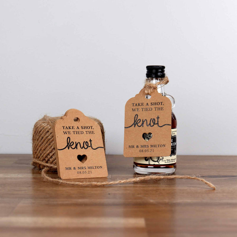 Mini bottle of alcohol with a custom swing tag for wedding favours.