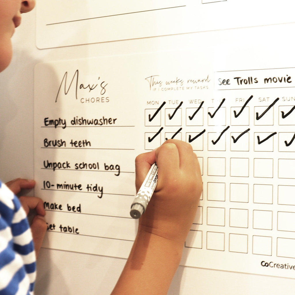 Kids chore chart showing child ticking off daily chores